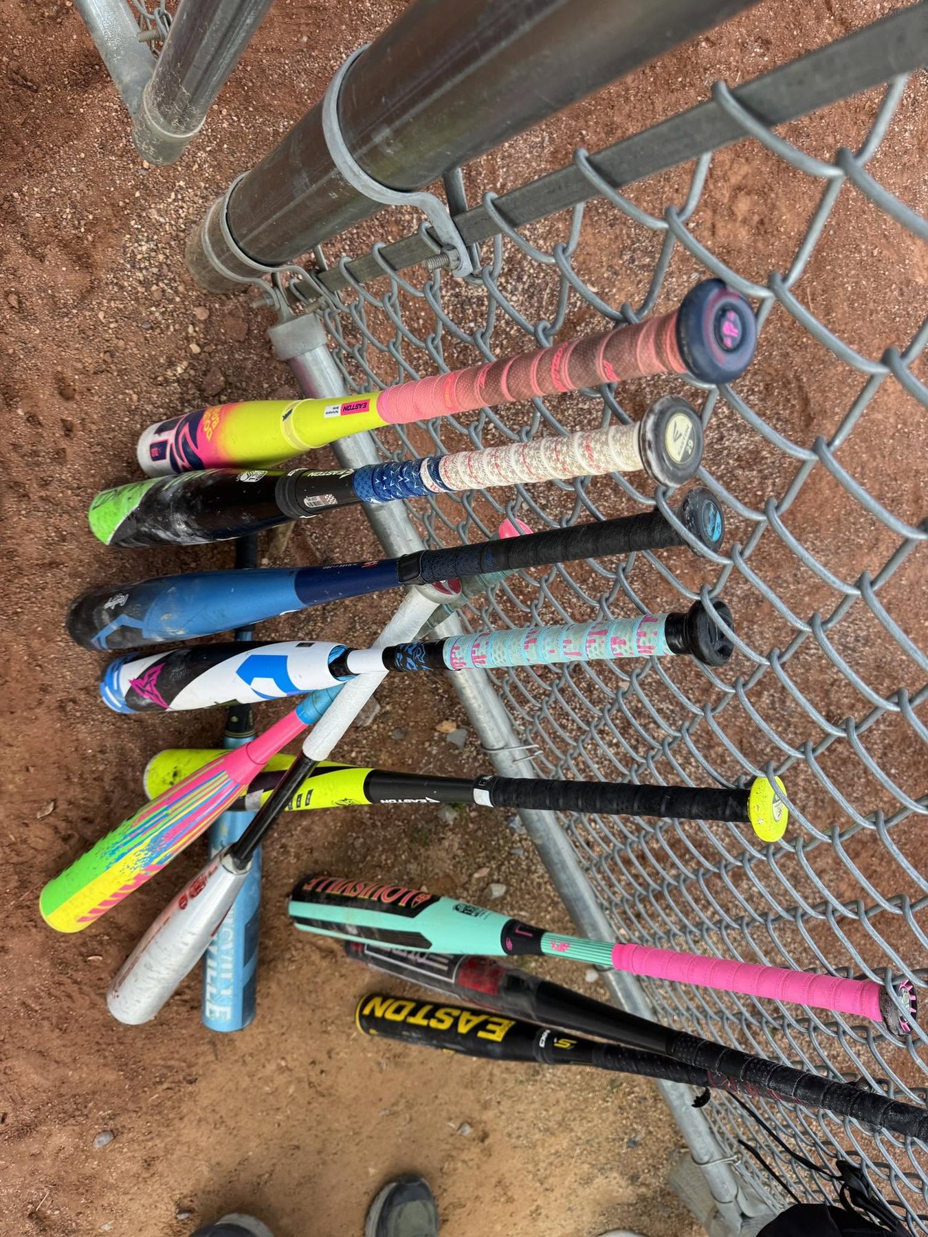 Baseball bats lined up at a field